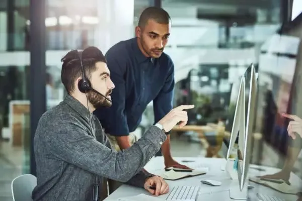 Two men working on a computer